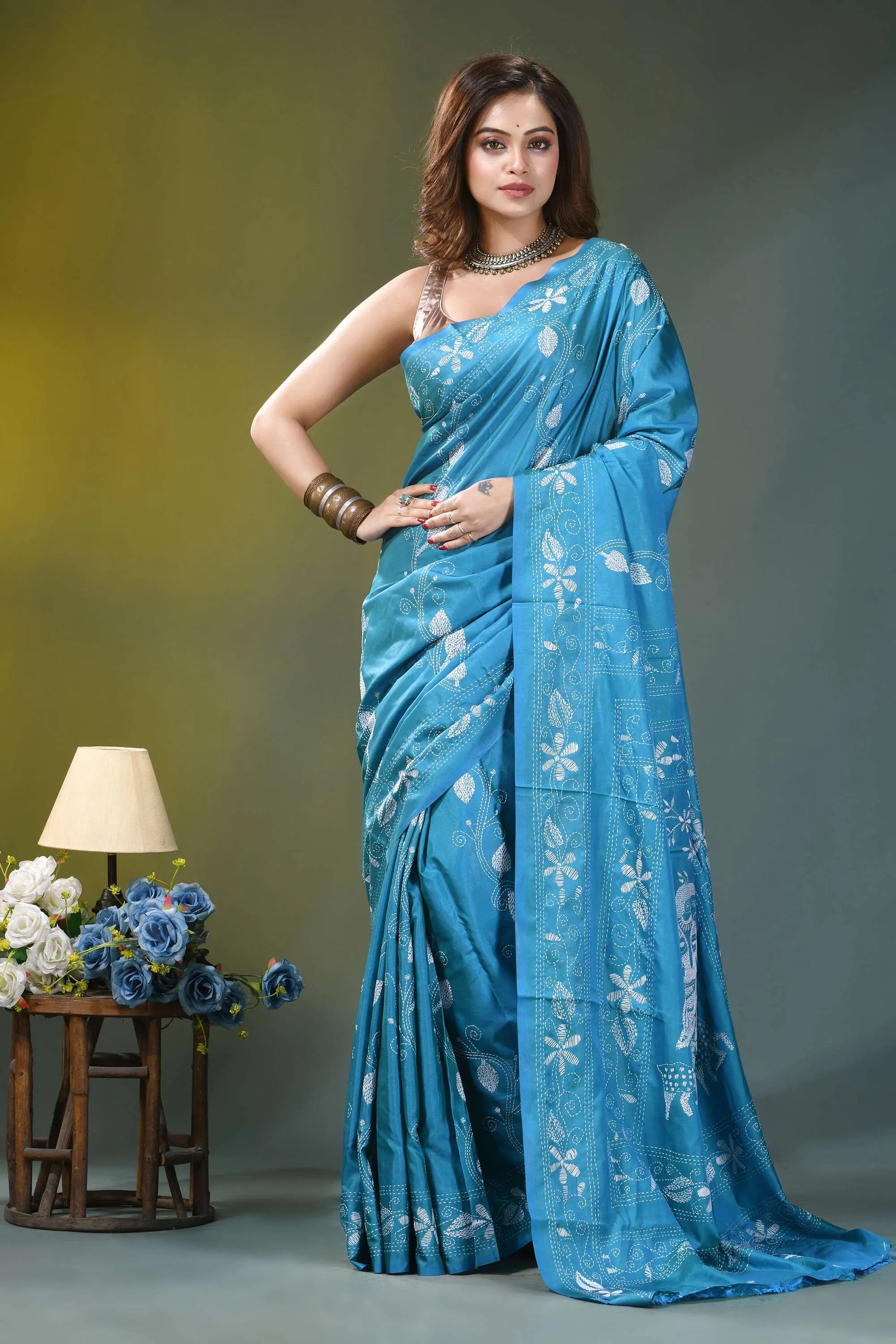 Sky blue nature theme artisanal silk kantha work saree woman wears vibrant blue silk 1