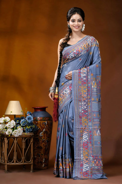 Slate grey multicolor geometric motif silk lambani embroidery saree woman wears light blue silk 1