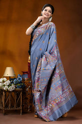 Slate grey multicolor geometric motif silk lambani embroidery saree woman wears light blue saree 4