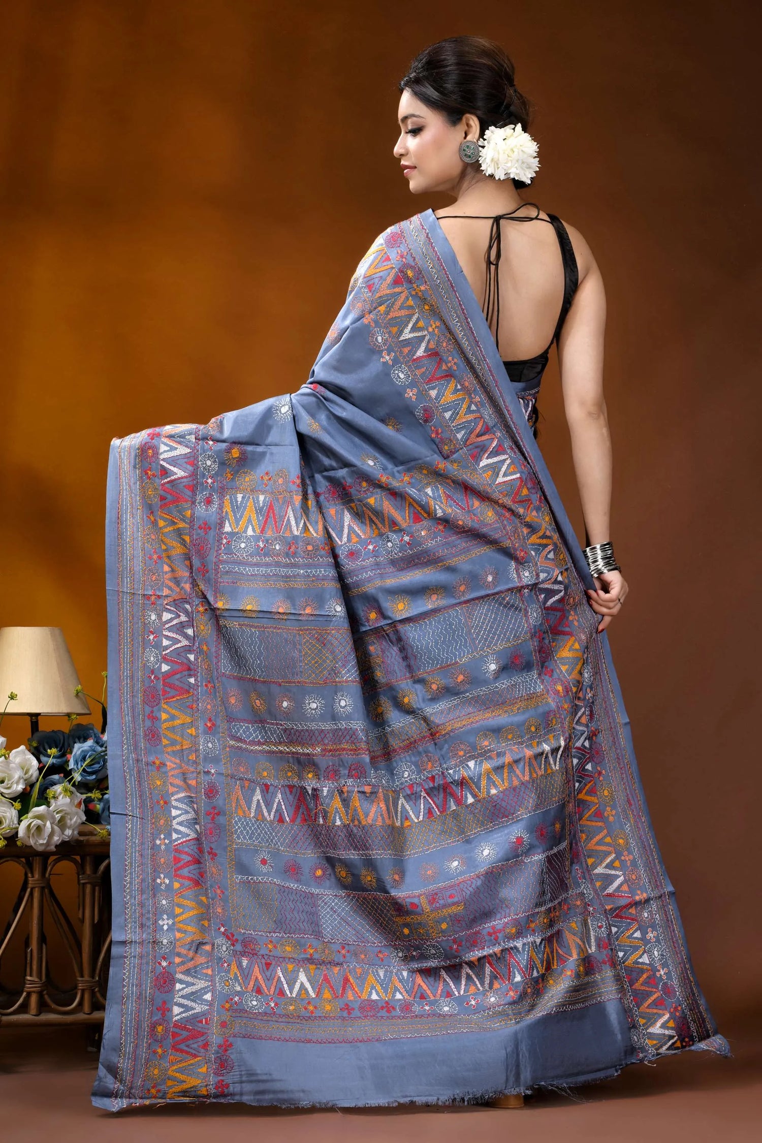 Slate grey multicolor geometric motif silk lambani embroidery saree woman wears light blue saree 5