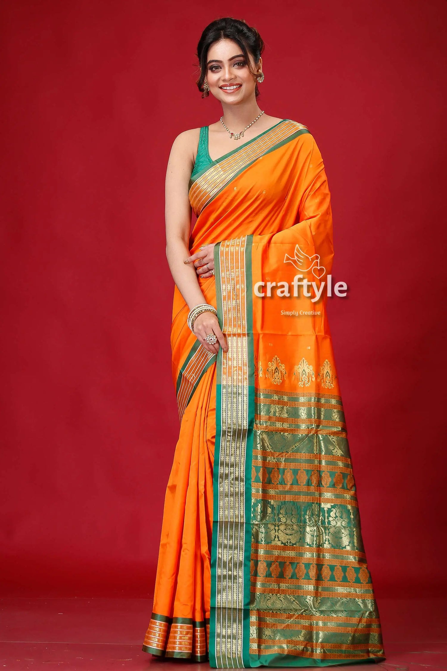 Spanish orange bomkai silk sari featuring golden zari border orange green silk saree 1