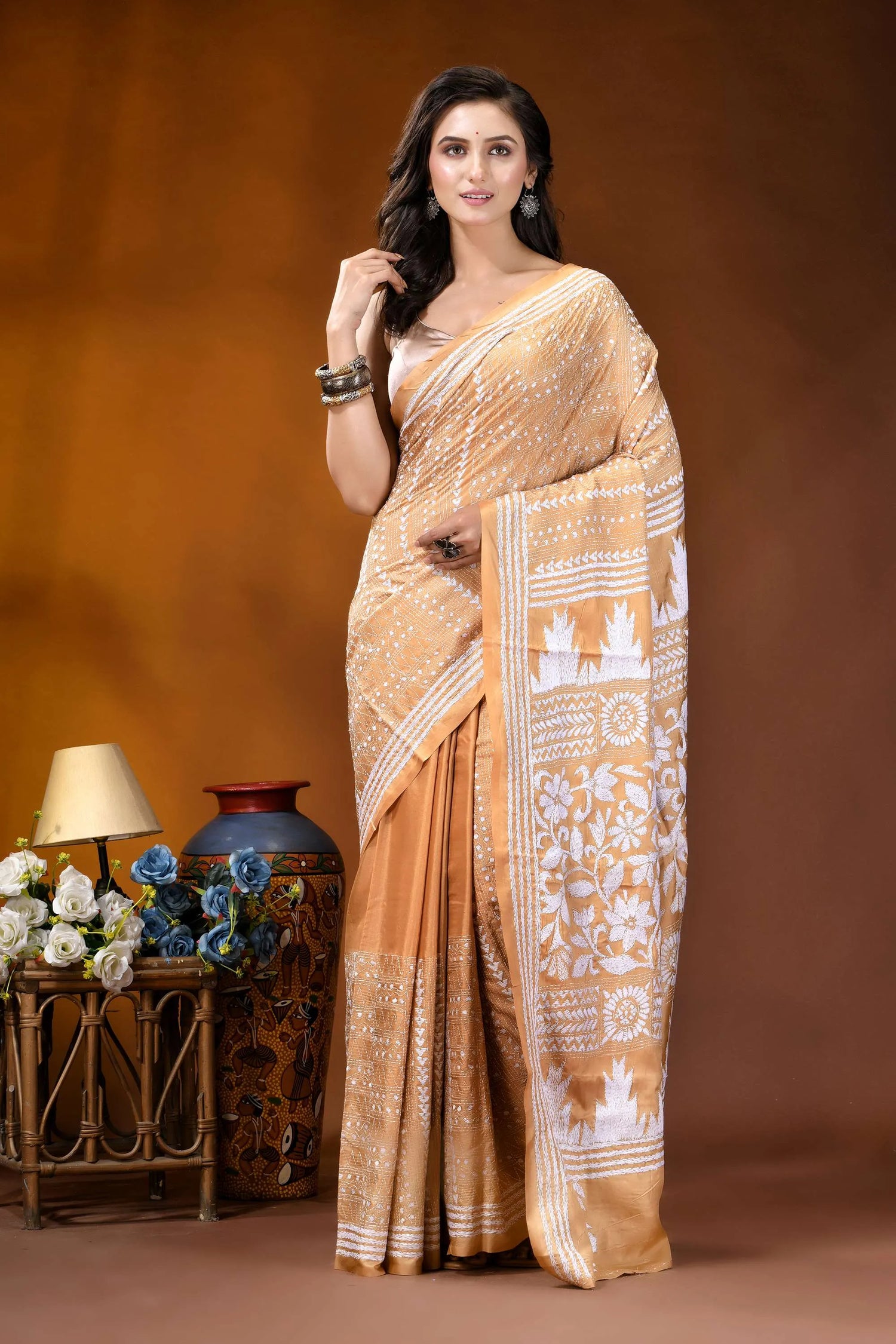 Tan floral motif handcrafted kantha embroidery silk saree woman wears beige white patterned 1