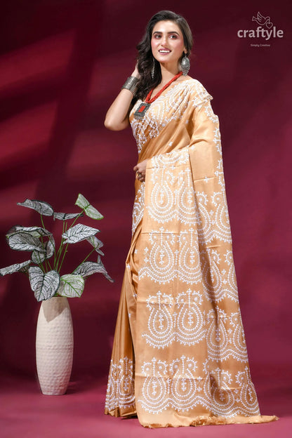 White thread hand gujrati embroidery silk saree in tan color woman wears golden-brown saree intricate 3